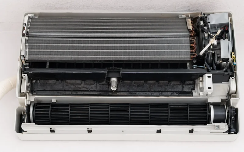 Aircon fan coil cross-section showing coil, drain pan, and blower zones