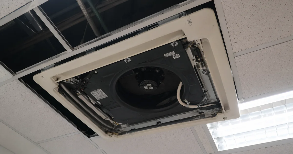 Ceiling cassette aircon in Singapore office with tiles removed