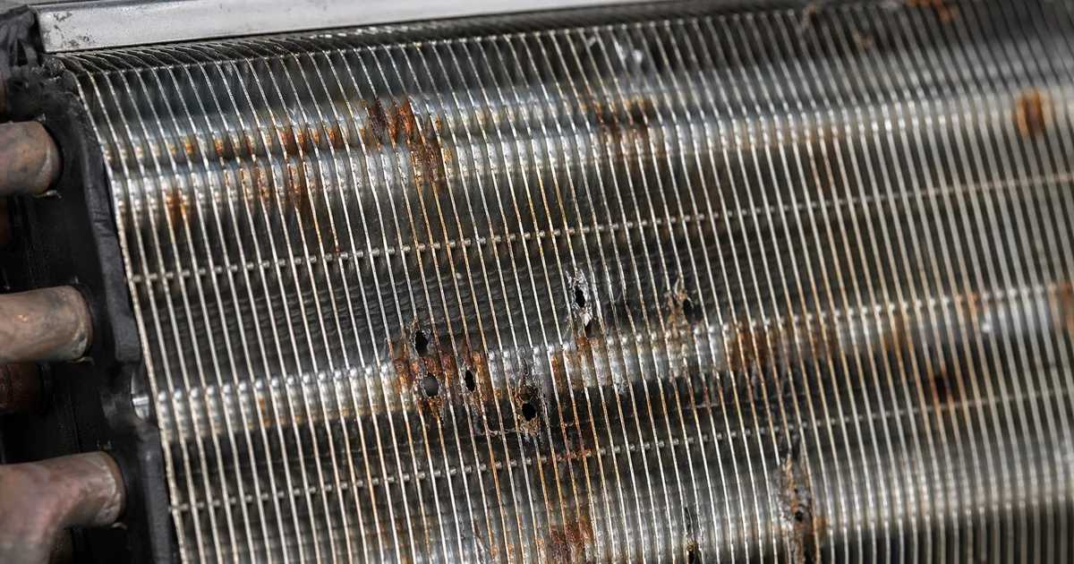 Corroded aircon coil fins from DIY chemical cleaner damage